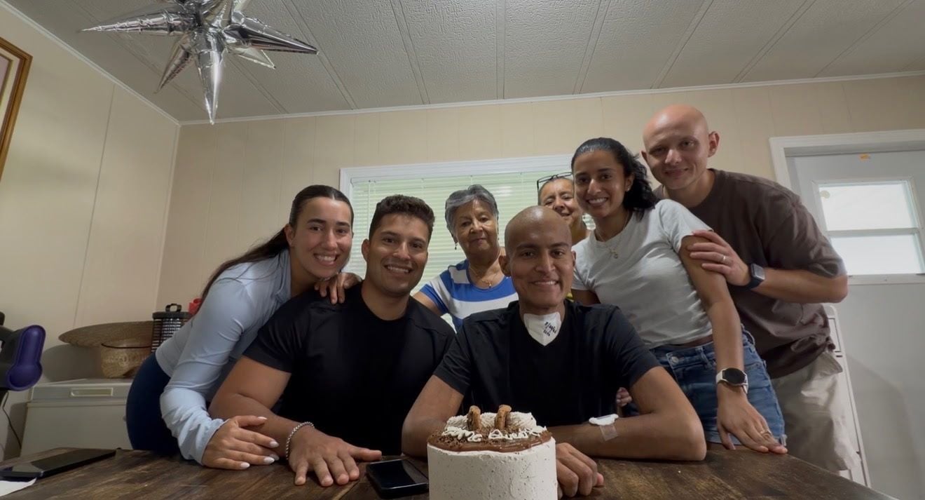 August 22, 2026 — Karamat home with his family around a 'Home Sweet Home' cake