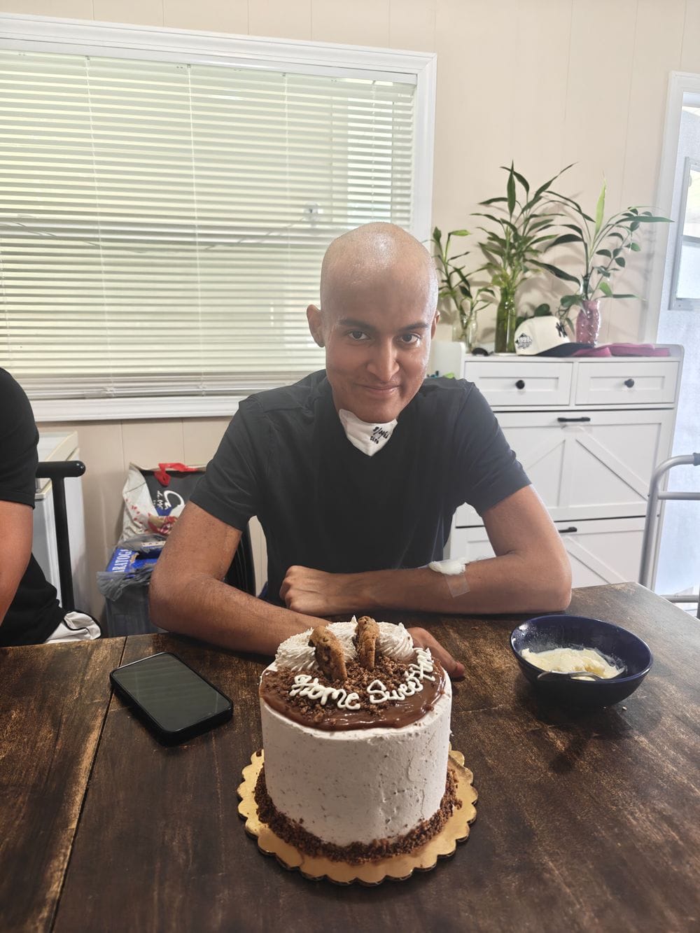 Karamat at the kitchen table on the day he came home, August 22, 2026