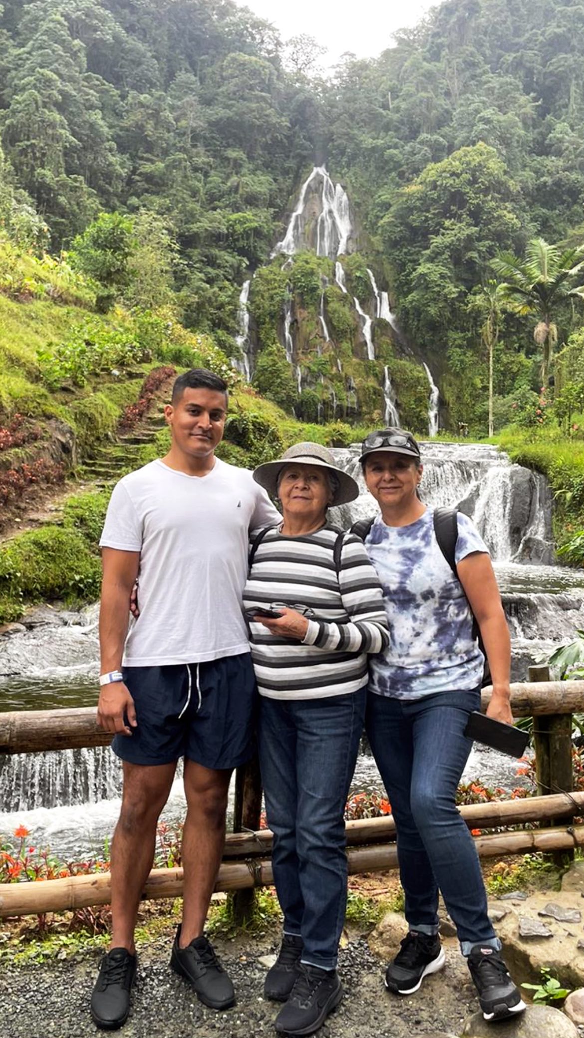 Karamat with his mother and grandmother at a waterfall in Ecuador
