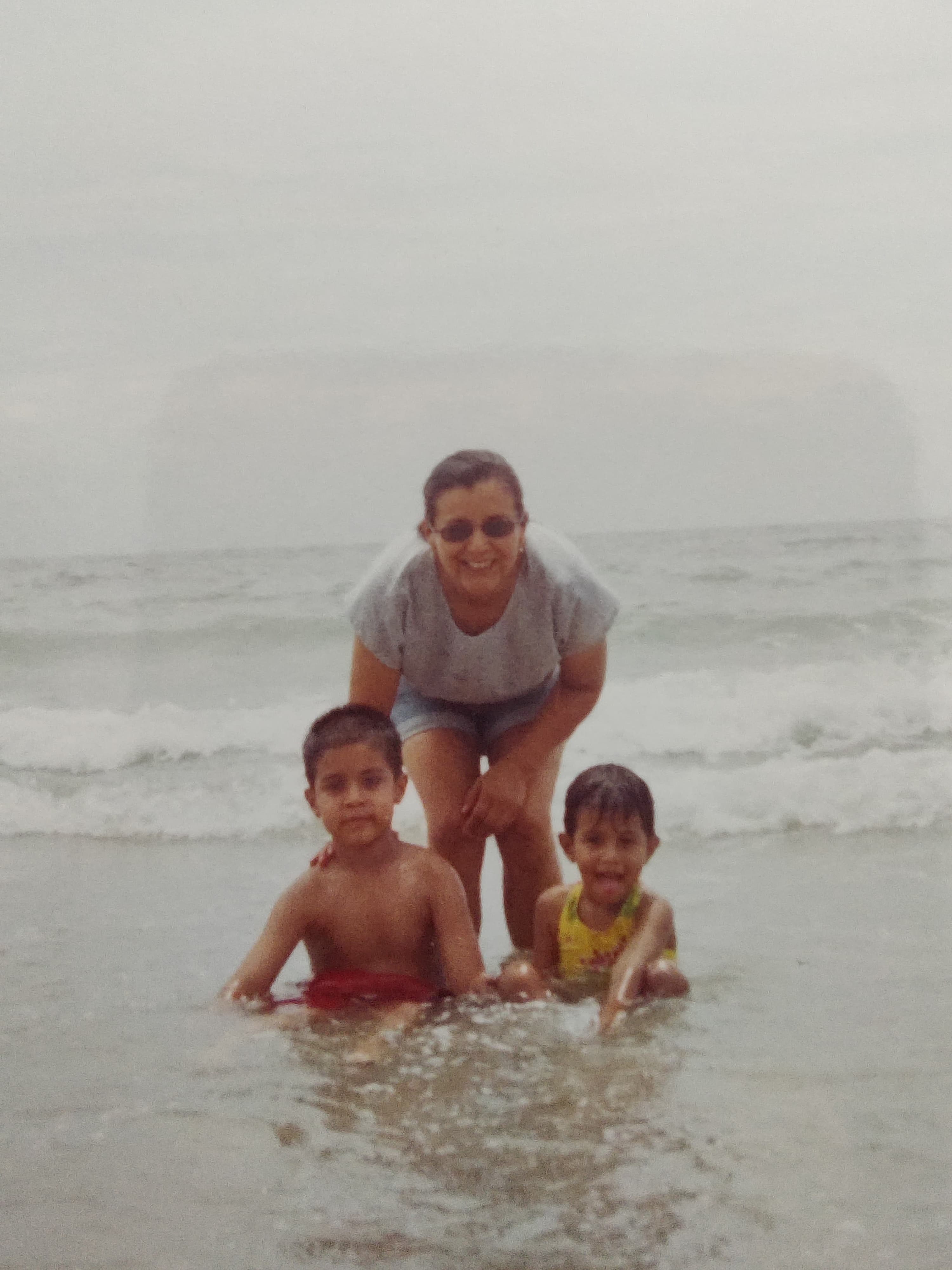 Young Karamat with family at the beach