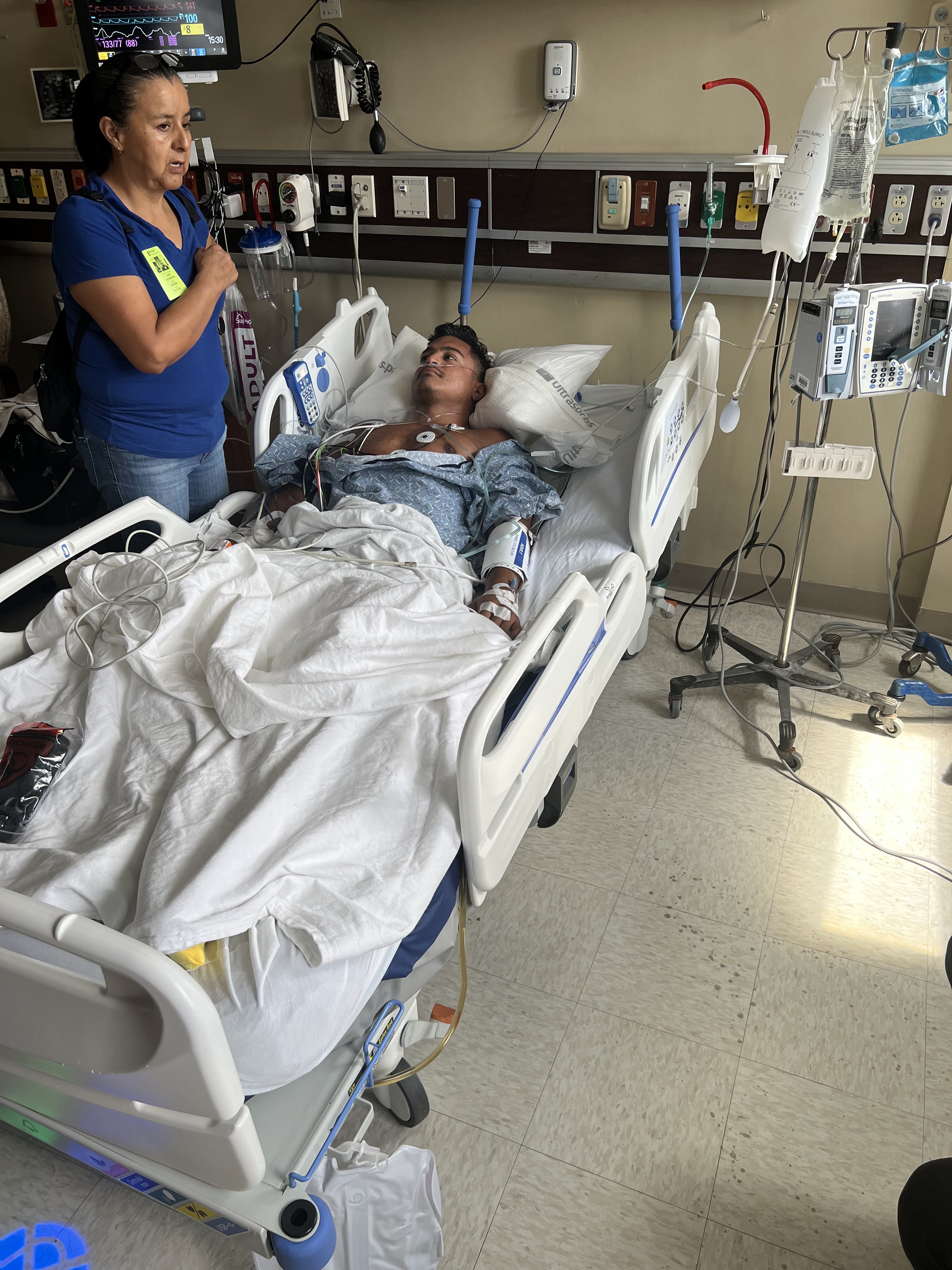 Karamat in the hospital with his mother by his side